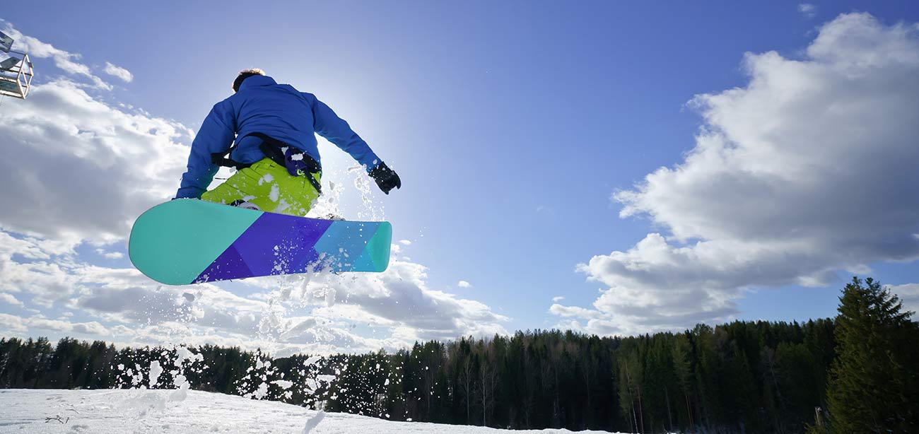 A snowboarder does a stunt on the snow